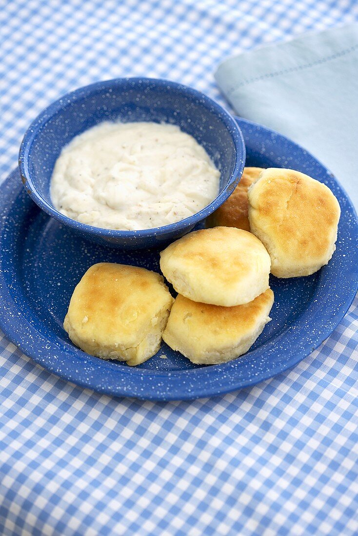 Biscuits on a Plate with a Bowl of Gravy