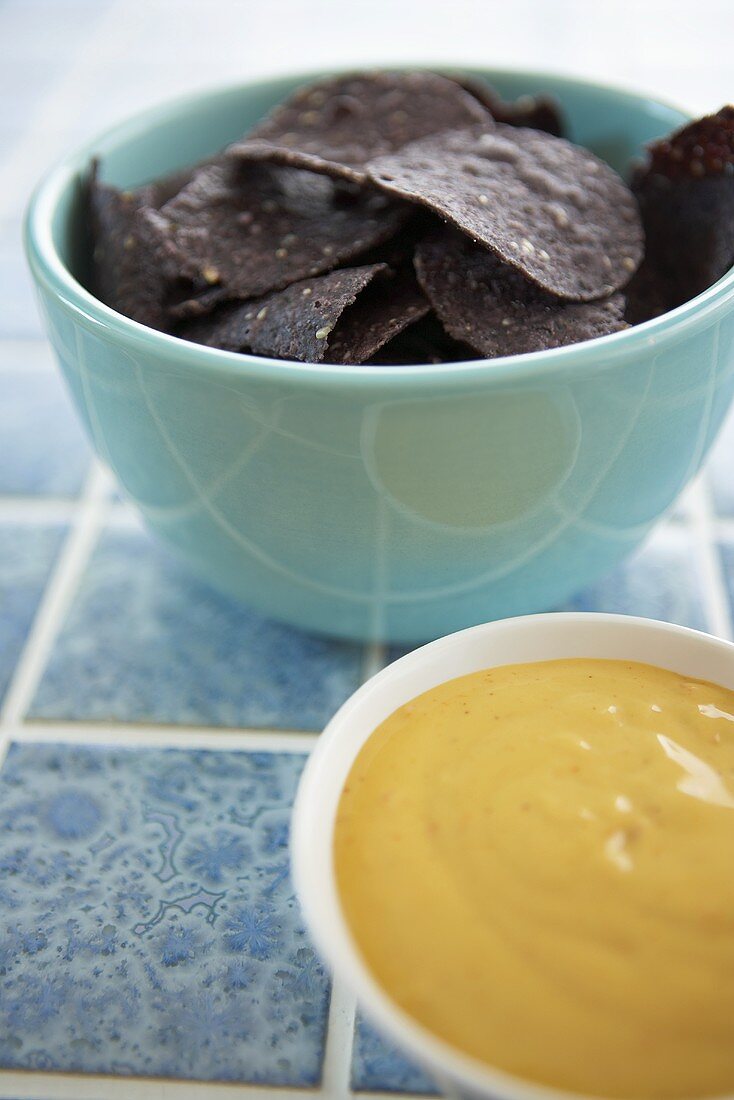Bowl of Blue Sesame Tortilla Chips with Jalapeno Cheese Dip