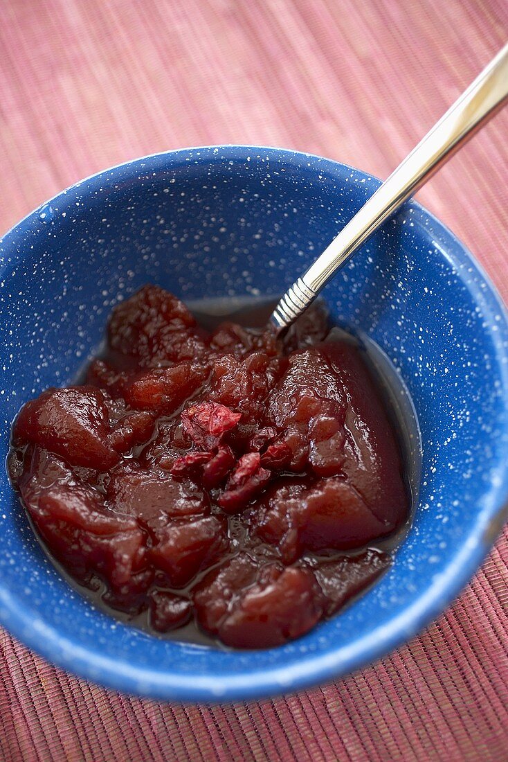 Chunky Cranberry Sauce in a Blue Bowl with Spoon