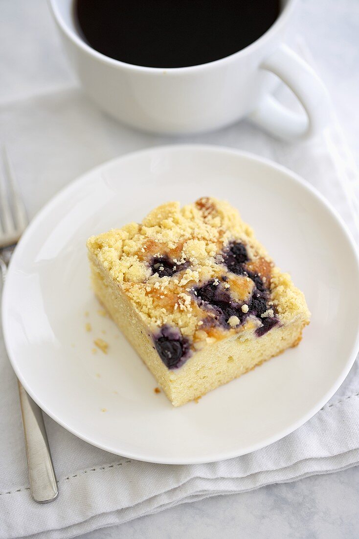 Piece of Blueberry Crumb Coffee Cake with a Cup of Coffee