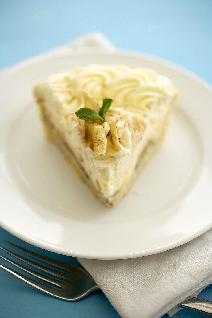 Slice of Banana Cream Pie on a White Plate; Blue Background