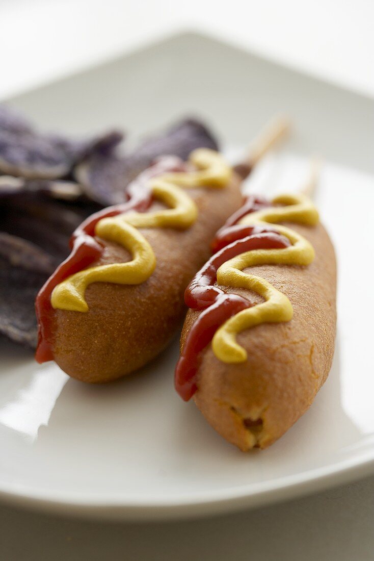 Two Corn Dogs with Ketchup and Mustard; Blue Chips