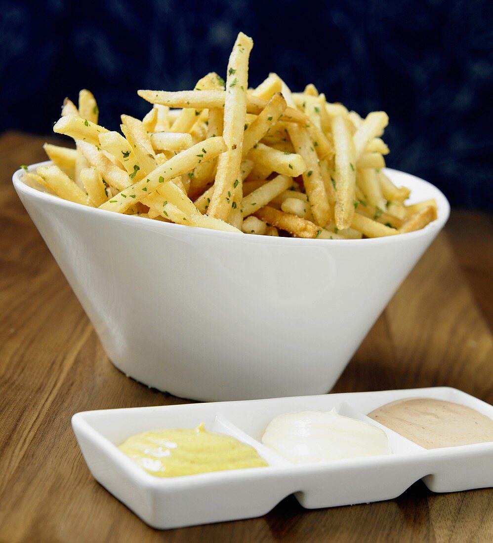 French Fries in White Bowl with Three Different Dips