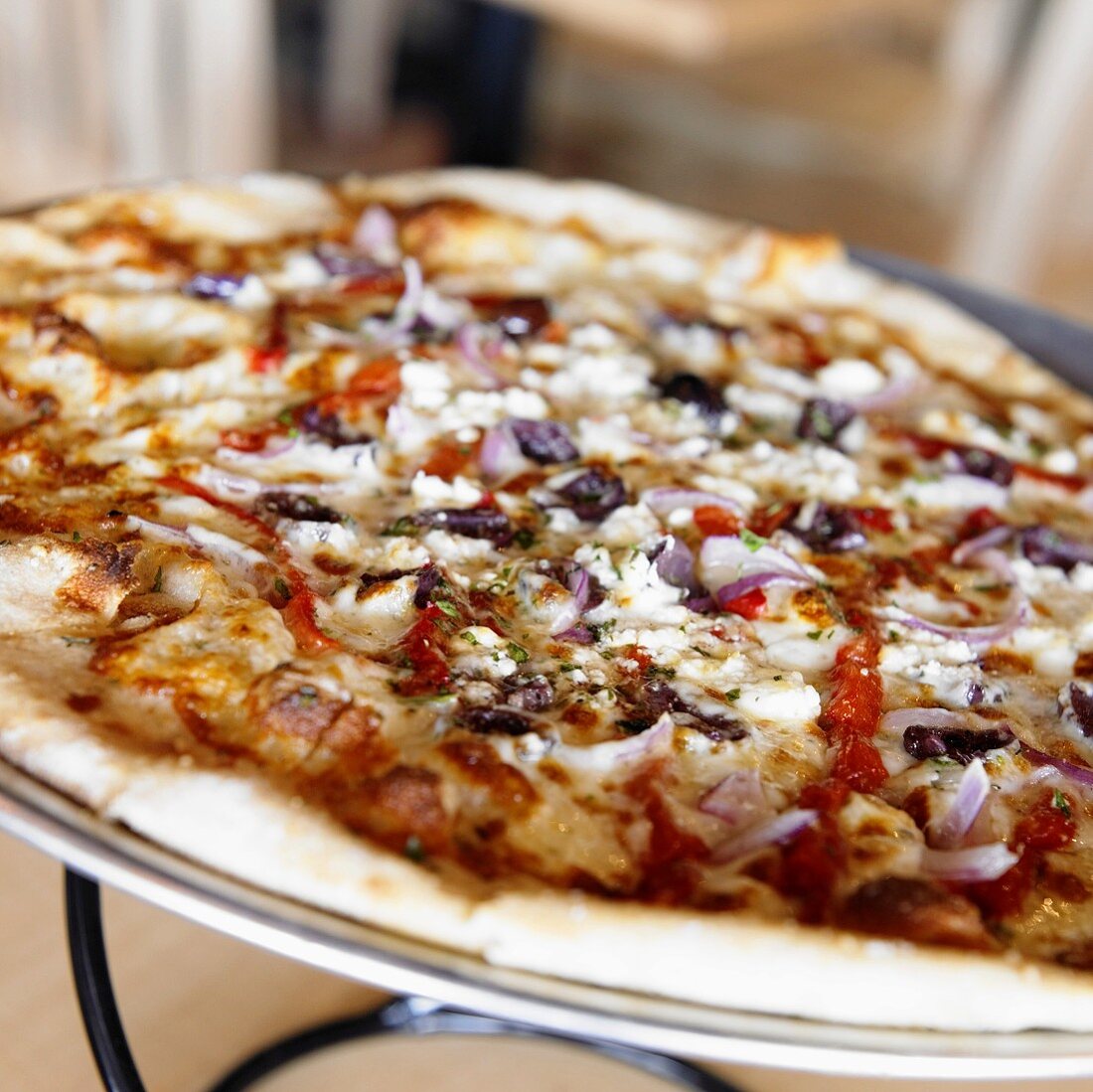 Close Up of Pizza Topped with Olives and Red Onion