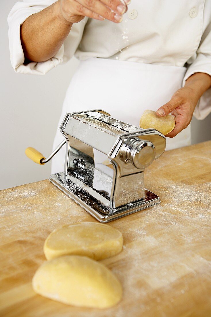 Making Pasta: Putting Pieces of Dough into a Pasta Maker