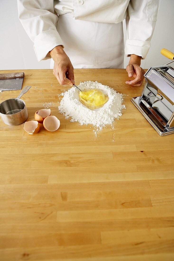 Making Pasta: Beating Eggs in Flour