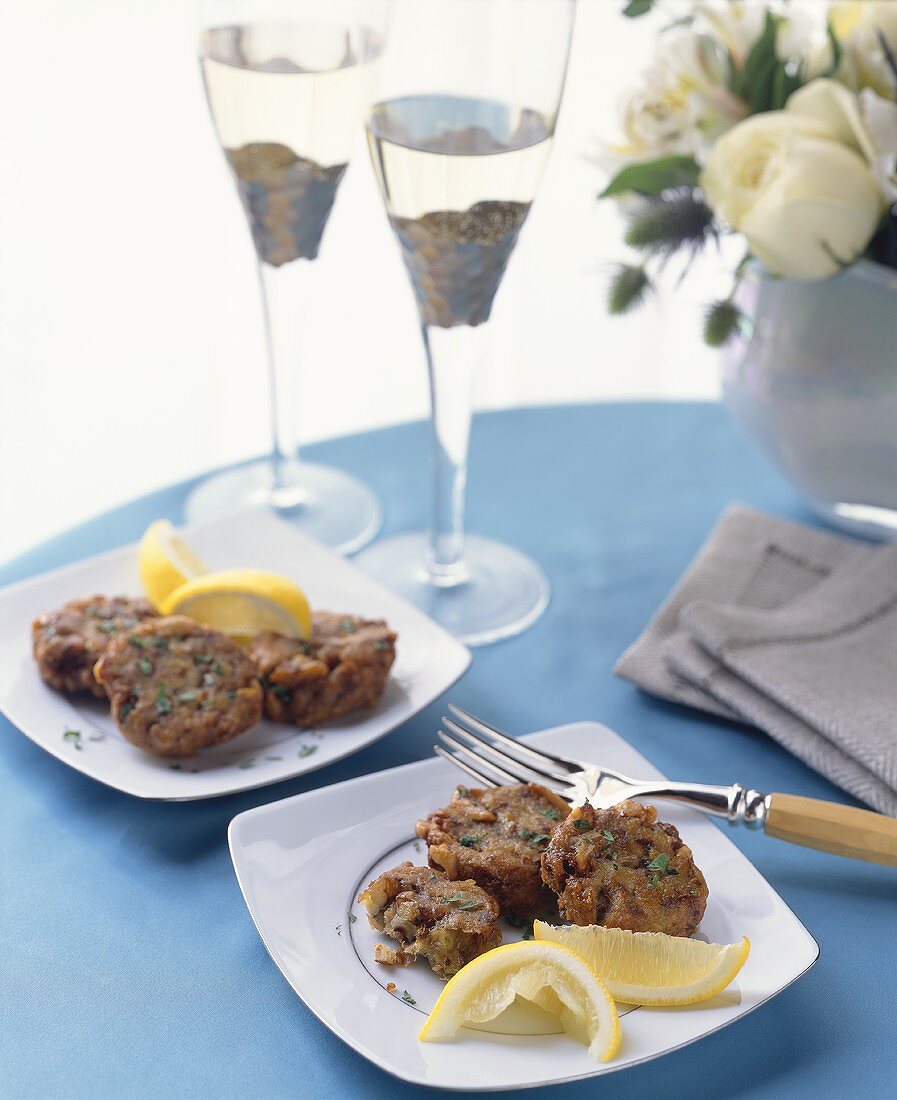 Crab Cakes with Lemon Wedges and Champagne