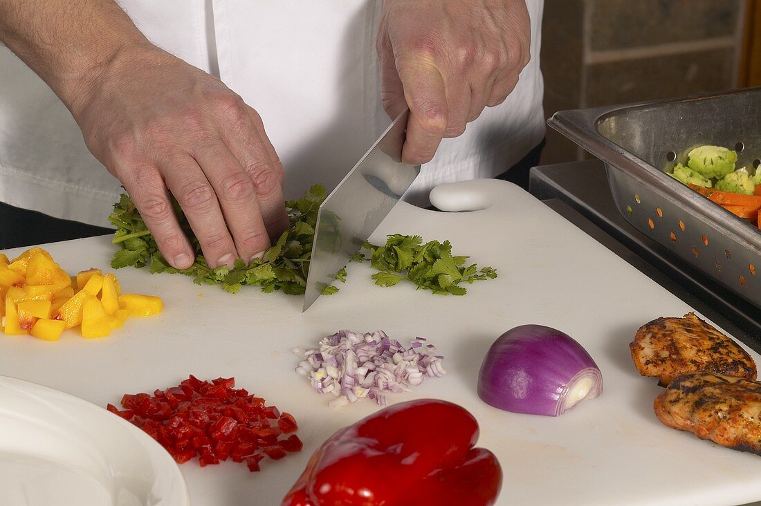Chef Chopping Assorted Ingredients on a Cutting Board