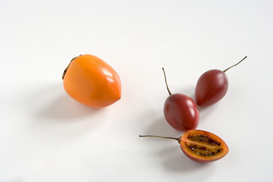 Persimmon and Tamarillo on a White Background