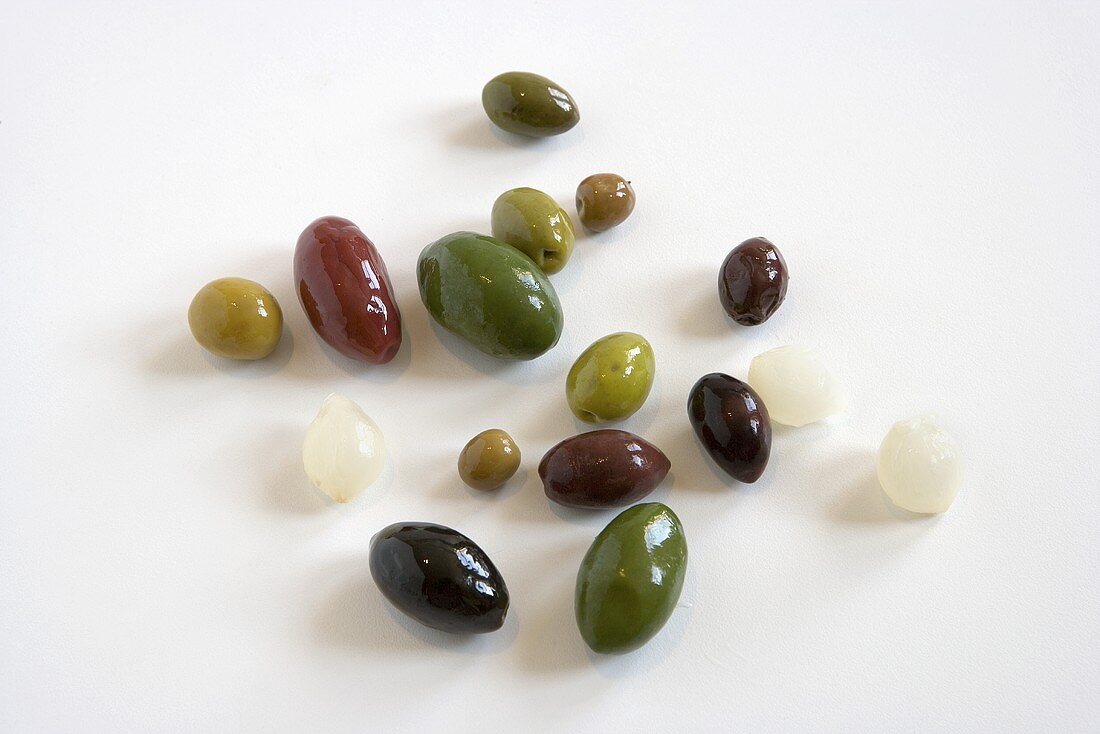 Various Olives & Pickled Silverskin Onions on White Background