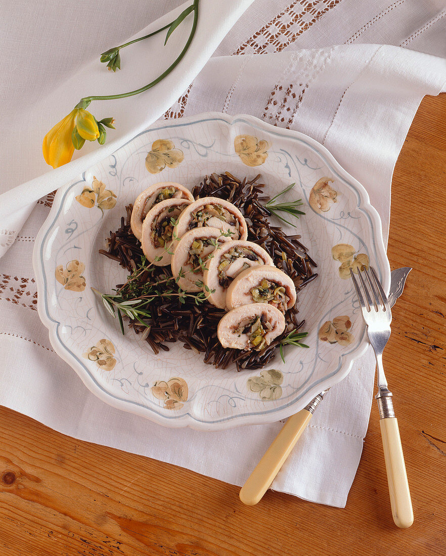 Prosciutto and Leek Rolled Chicken Sliced Over Wild Rice