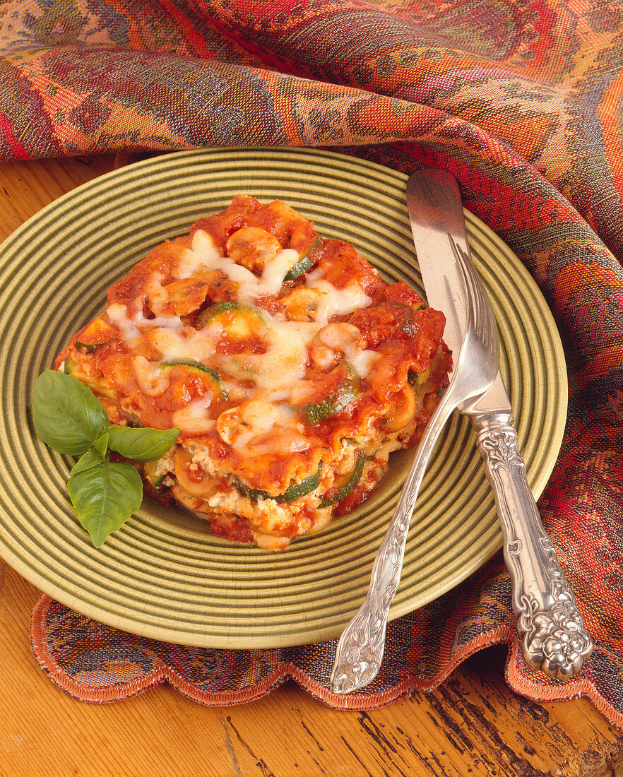 Piece of Vegetable Lasagna with Fork and Knife