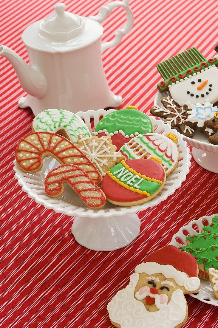 Festive Christmas Cookies and a Tea Pot on a Red Striped Table Cloth