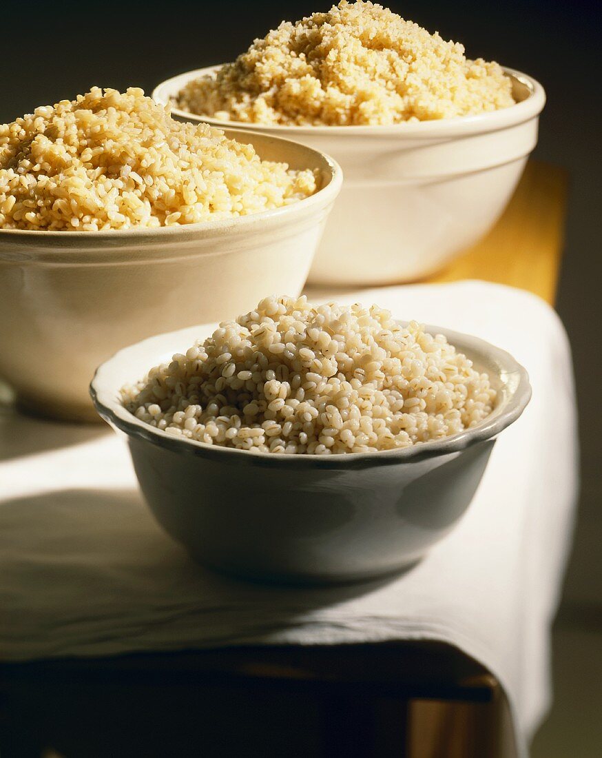Two Bowls of Cooked Grains; Barley and Rice; Bowl of Cooked Couscous