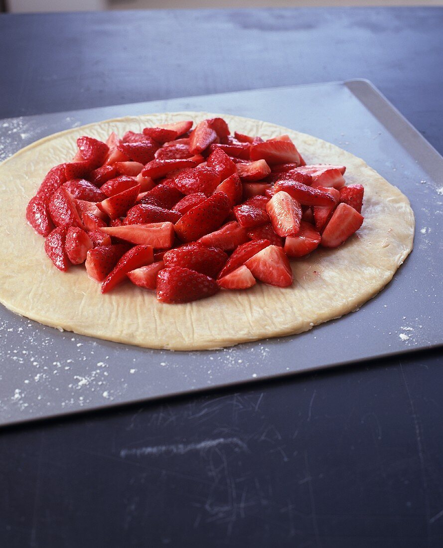 Quartered Strawberries on Rolled Out Pastry Dough
