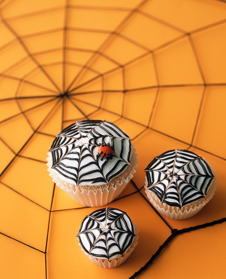 Three Spider Web Cupcakes on Spiderweb Table Top for Halloween