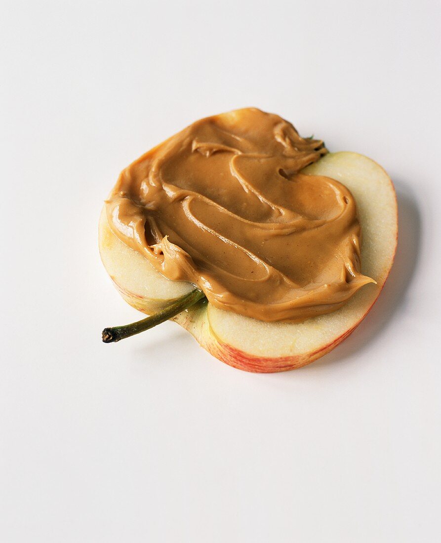 Peanut Butter Spread on an Apple Half; White Background