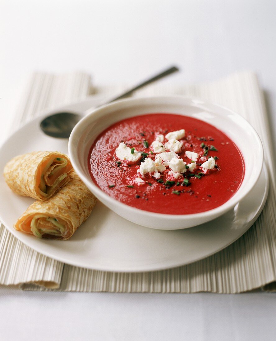 Bowl of Beet Soup with Goat Cheese; Salmon Cucumber Rolls