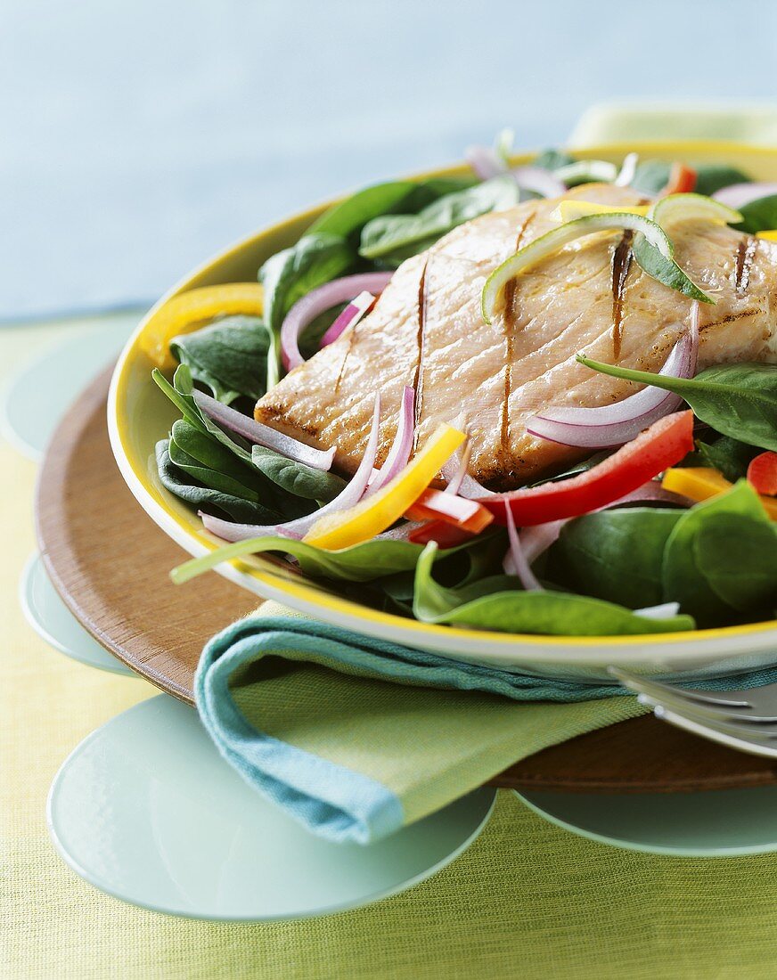 Gegrillter Lachs auf Spinatsalat mit Zwiebeln und Paprika