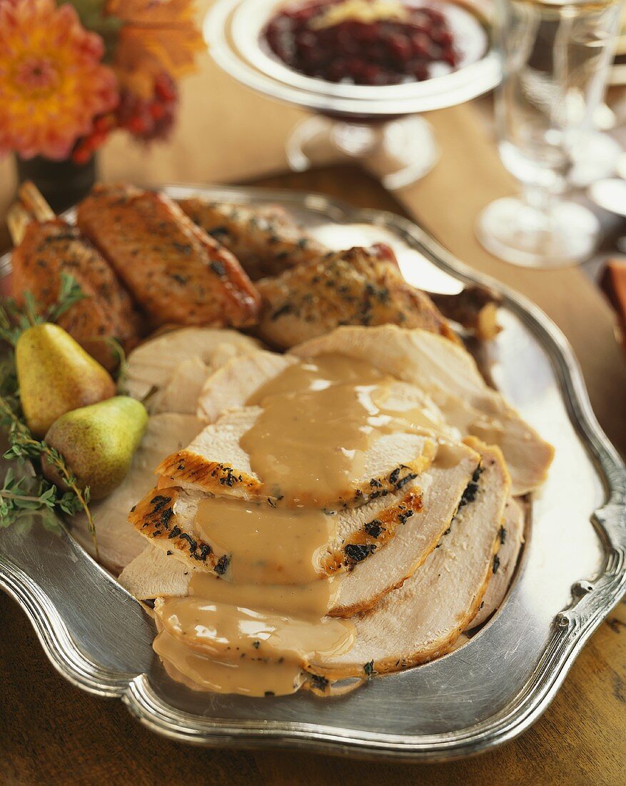 Sliced Roast Turkey with Gravy on a Silver Platter
