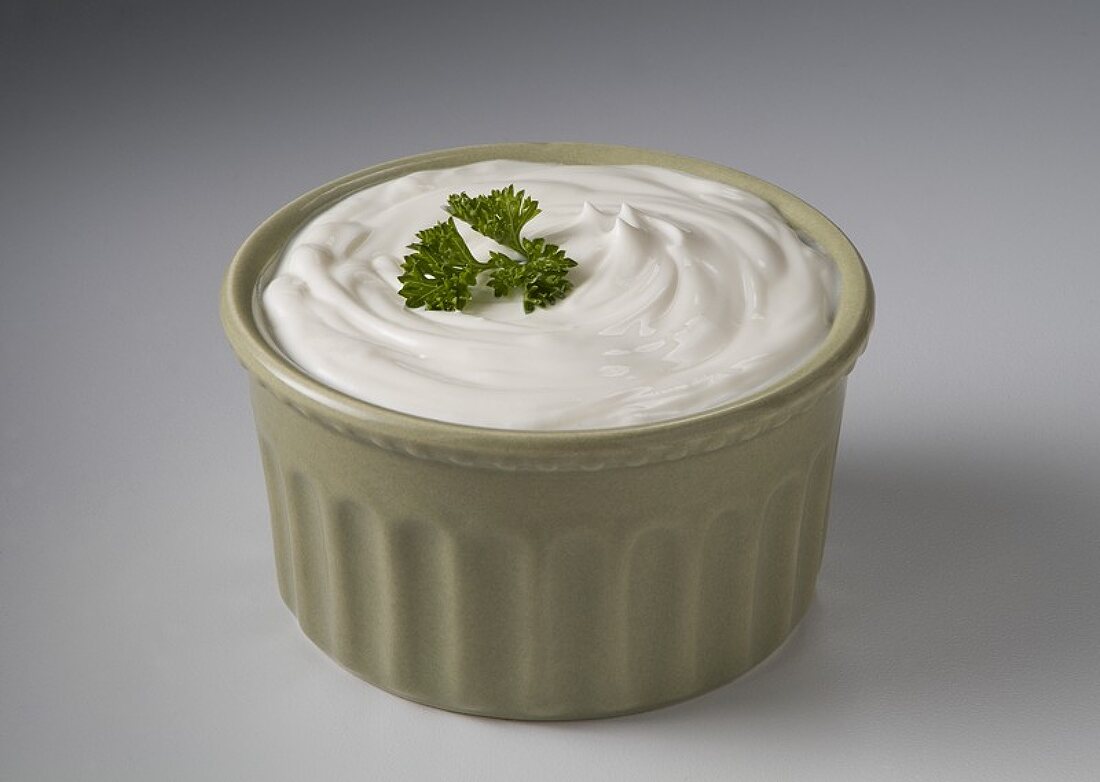 Sour Cream in a Green Bowl with Parsley