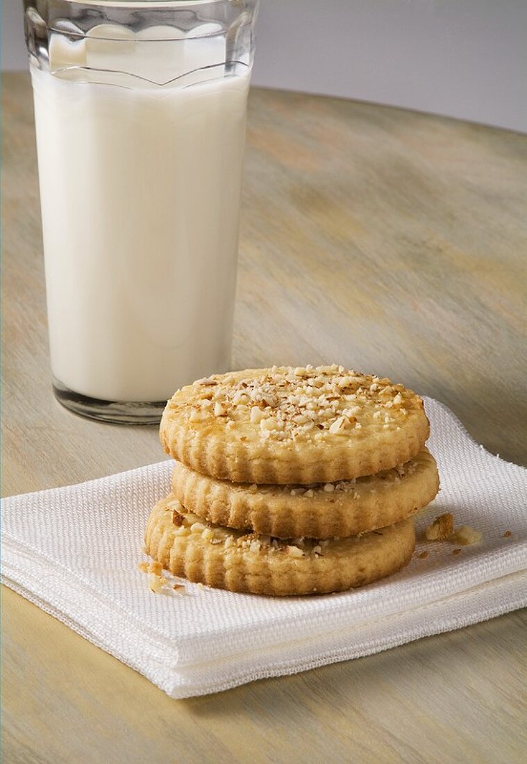 Three Almond Butter Cookies with a Glass of Milk