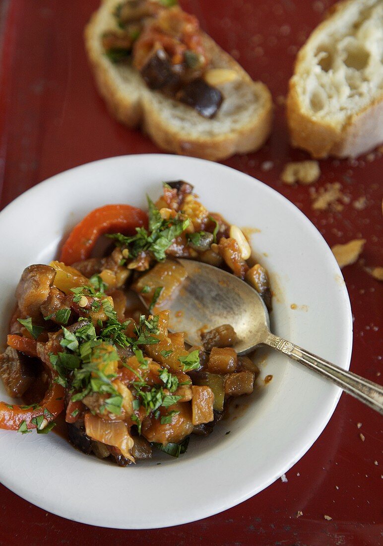 A plate of ratatouille with baguette