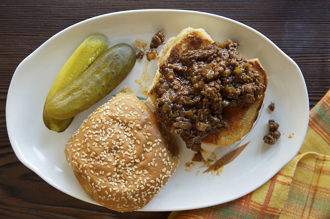 Open Sloppy Joe on a Plate with Pickles