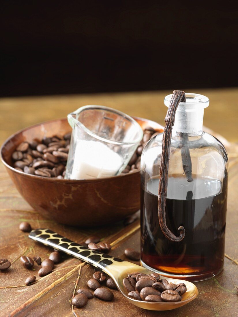 A bottle of coffee & vanilla liqueur with coffee beans & sugar