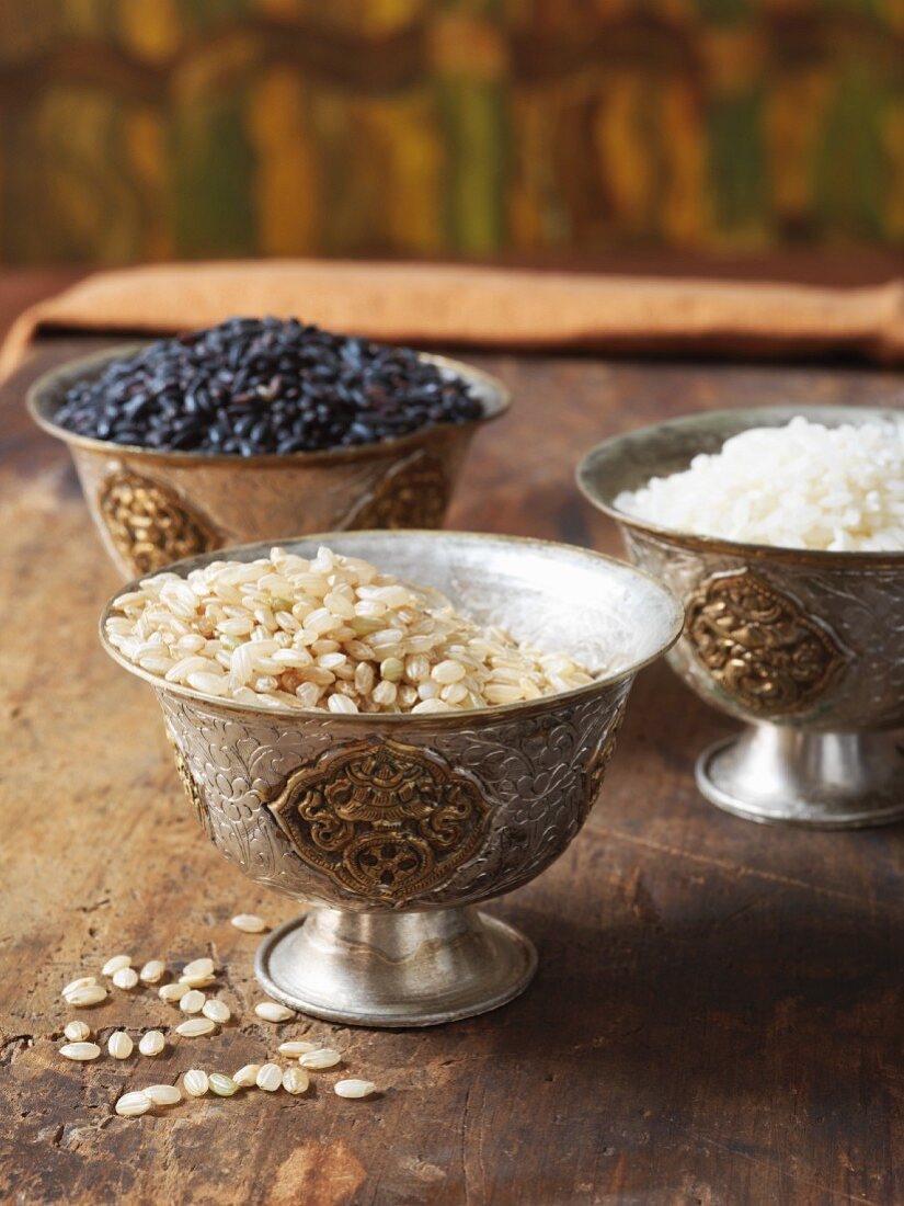 Three different types of rice in silver bowls