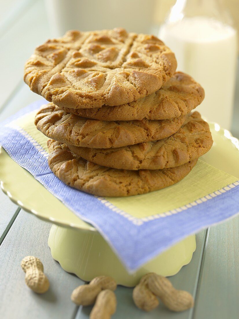 A Stack of Peanut Butter Cookies with Milk and Peanuts
