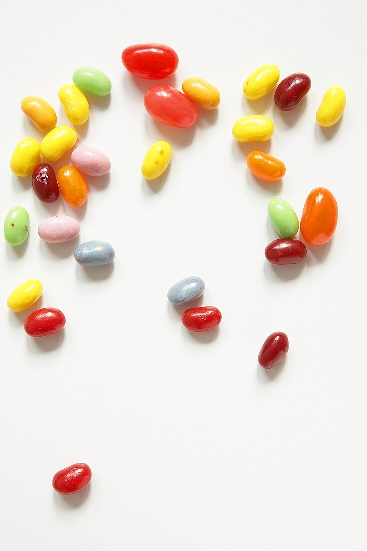 Various Jelly Beans Scattered on a White Background