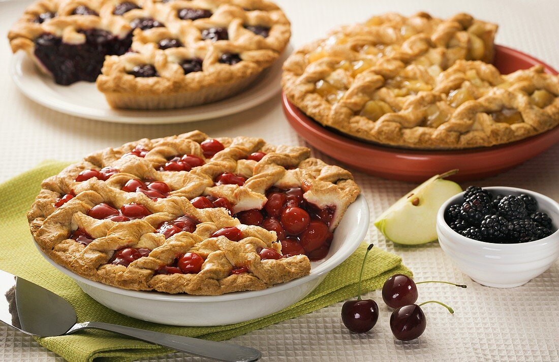 Three Assorted Fruit Pies with Slices Removed