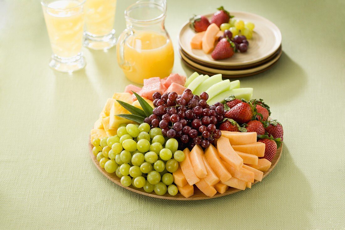 Fruit Platter with Orange Juice and Serving Plates