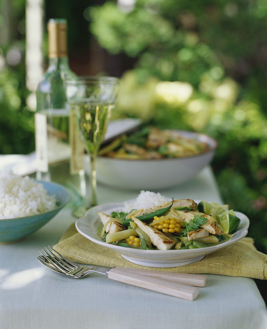 Grilled Chicken and Vegetables with Rice on Outdoor Table