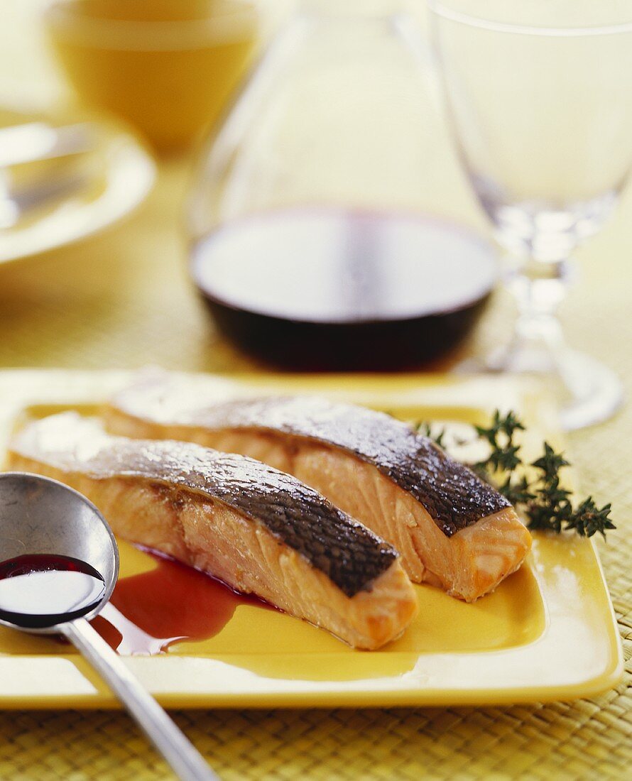 Two Salmon Fillets with Skin; Spoon with Sauce