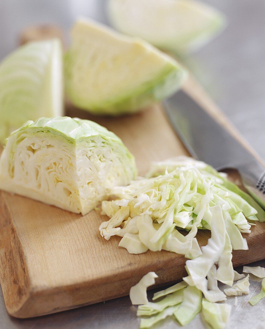 Partially Shredded Cabbage on Cutting Board