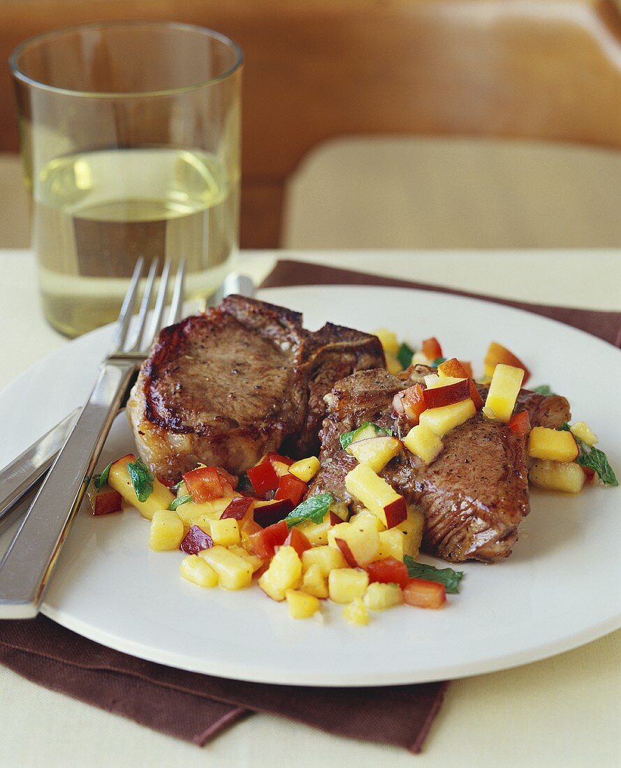 Pork Chops with Mango Salsa on a Plate with Fork and Knife