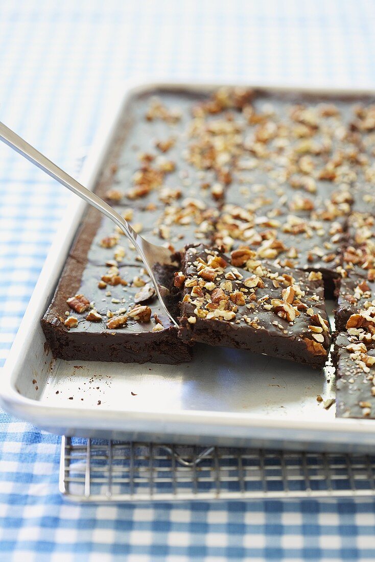 Schokoladenkuchen mit gehackten Nüssen auf Backblech