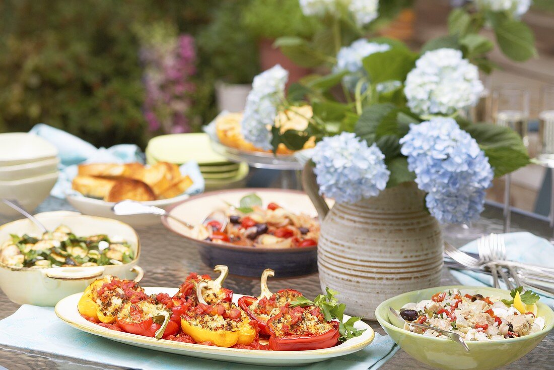 Table laid for a summer buffet, hydrangeas