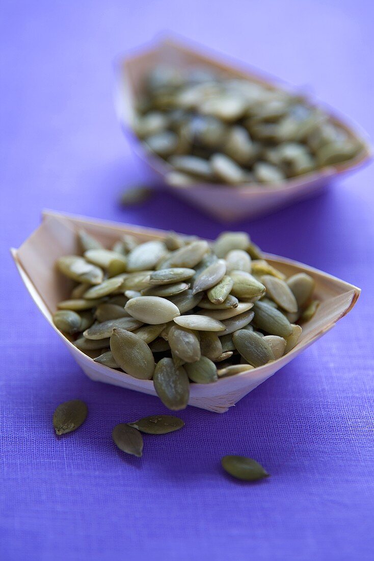 Two Wooden Bowls of Pumpkin Seeds