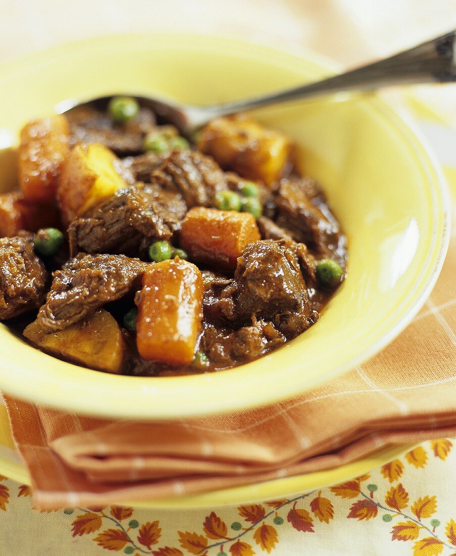Beef Stew in Yellow Bowl with Spoon