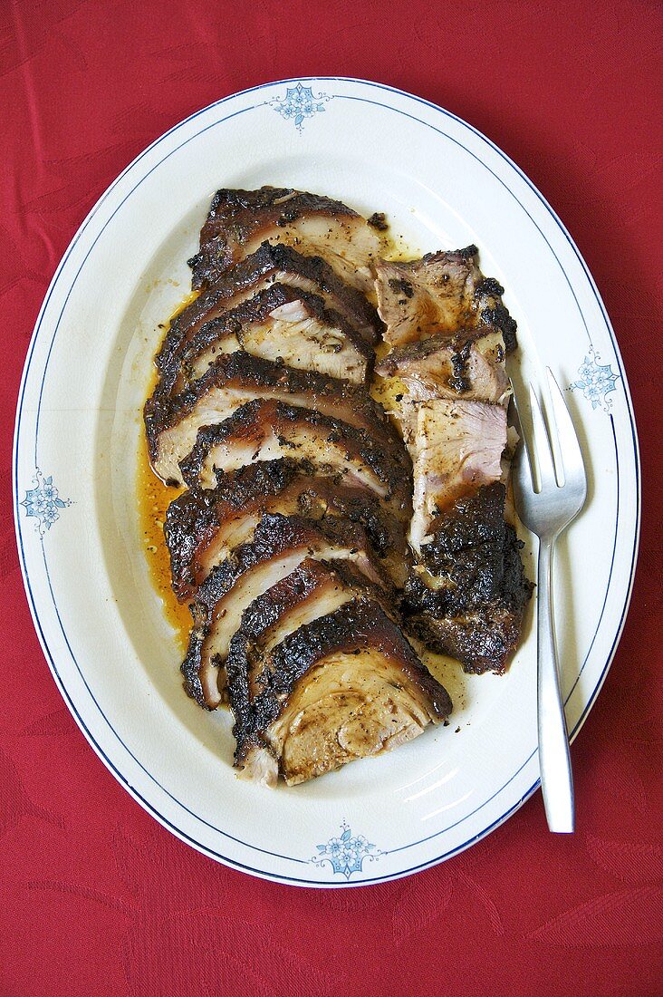Crisp Roast Pork Sliced on a Platter with Fork