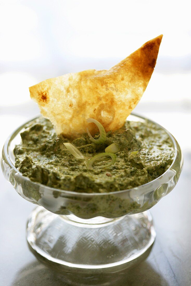 Chip Dipped in a Bowl of Spinach Dip