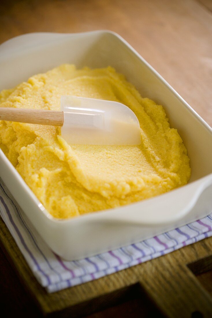 Spreading Polenta in a Baking Dish with Rubber Spatula
