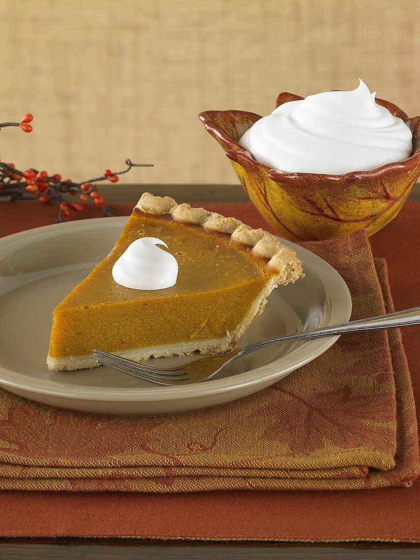 Slice of Pumpkin Pie with a Dollop of Cream