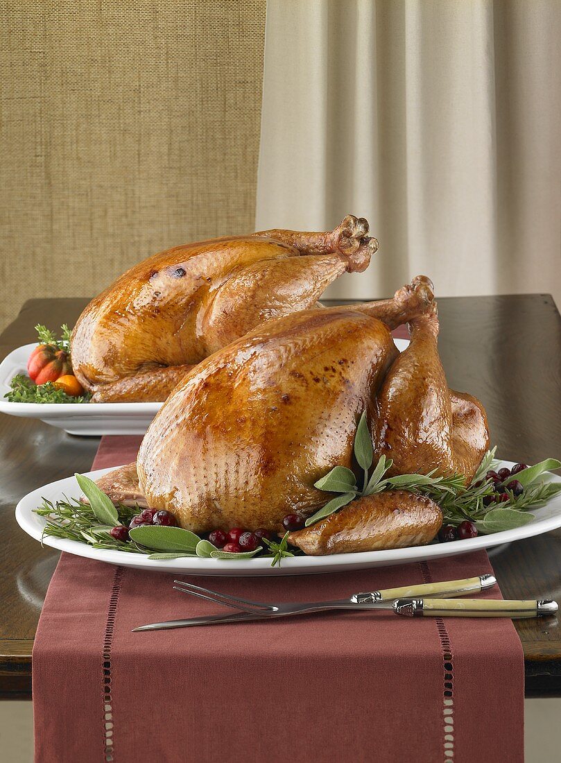 Two Whole Roast Turkeys on Platters