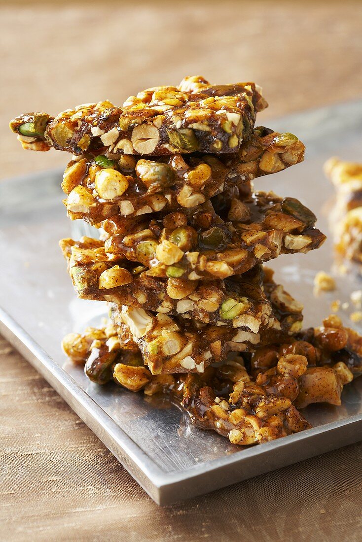 Stack of Spicy Nut Brittle Made with Assorted Nuts