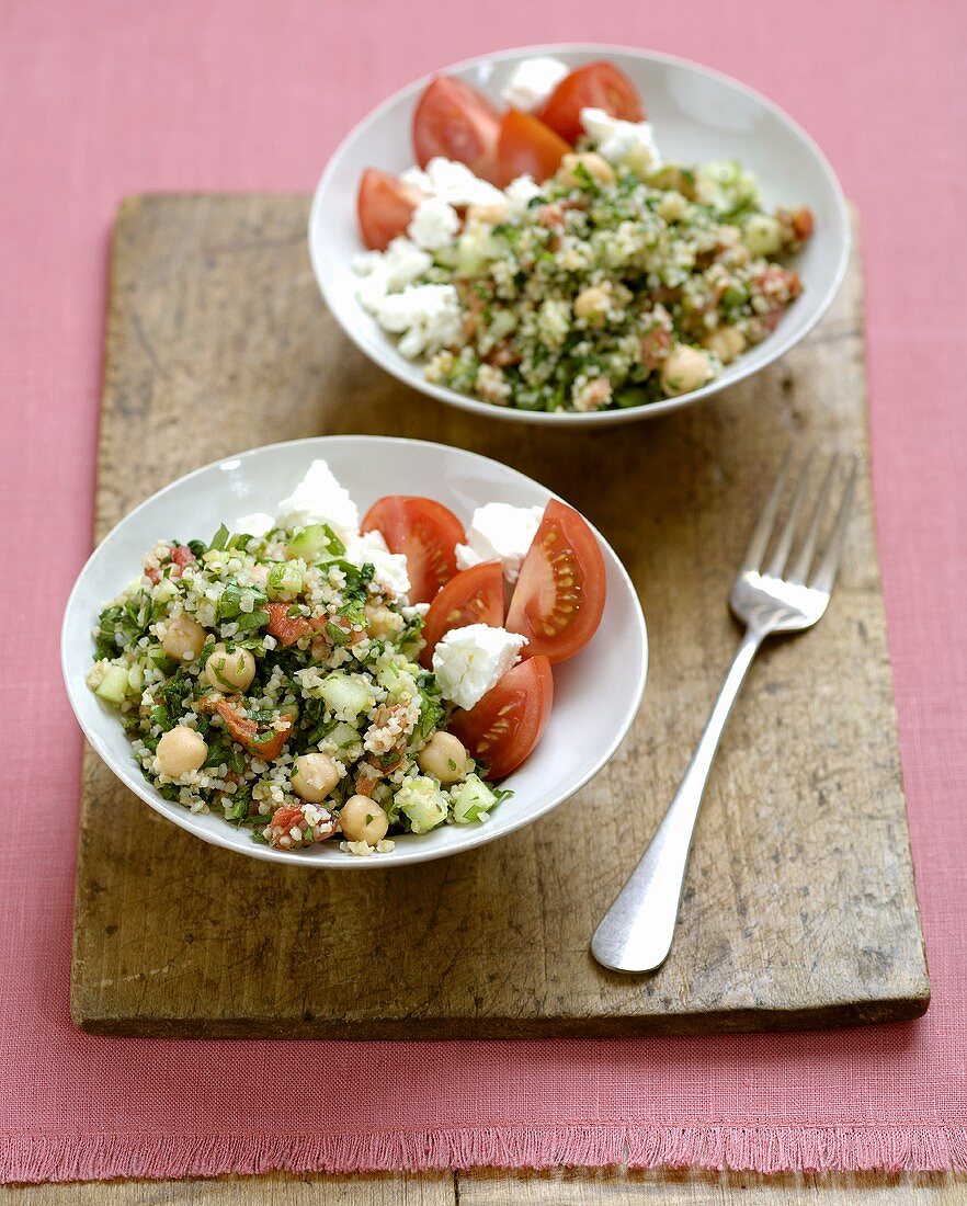 Two Bowls of Tabouleh with Tomato and Cheese Salad