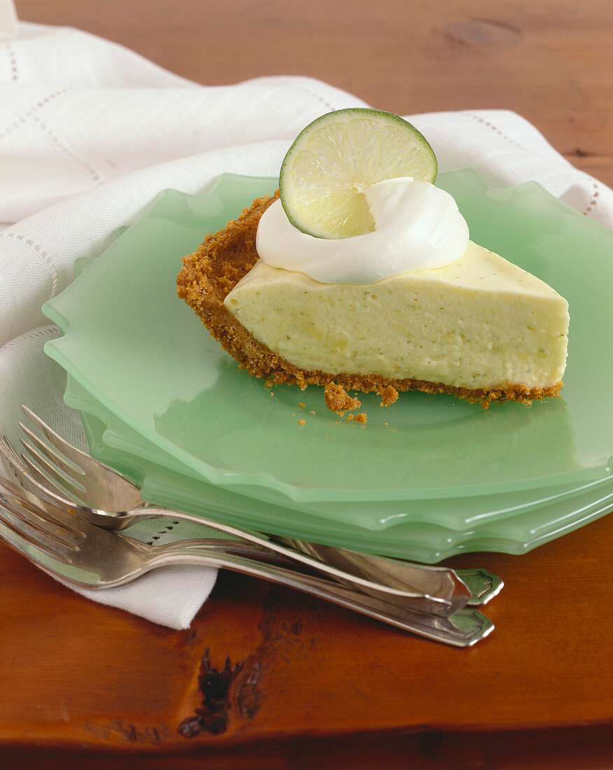 Slice of Lime Chiffon Pie on Stacked Plates